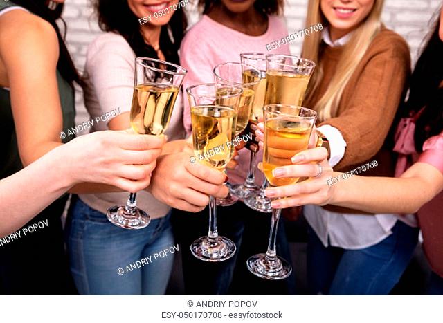Close-up Of Women Celebrating A Bachelorette Party And Clinking Champagne Glasses