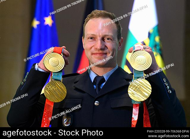 28 March 2022, Saxony, Dresden: Francesco Friedrich, four-time Olympic bobsleigh champion, presents his gold medals from Beijing 2022 and Pyeongchang 2018 at...