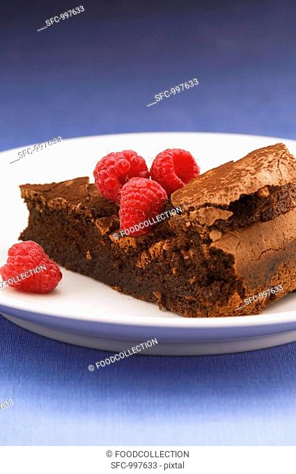 Piece of flourless chocolate cake with raspberries