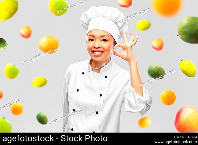 happy smiling female chef showing ok hand sign