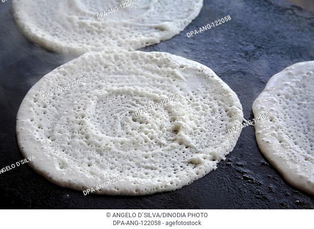 Dosa preparation ; Dosa on hot plate ; South Indian bread
