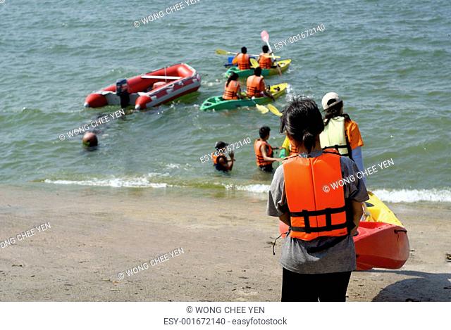 Students canoe activity at seaside
