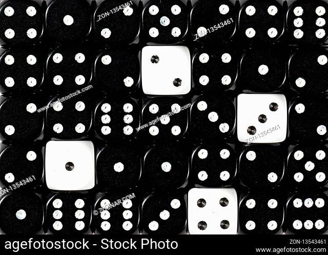 Pattern background of random ordered black dices with four white cubes