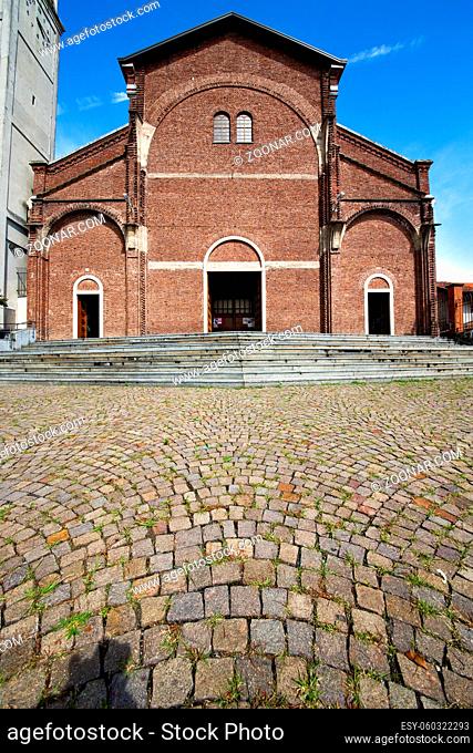 in the cardano al campo old  church closed brick tower sidewalk italy lombardy