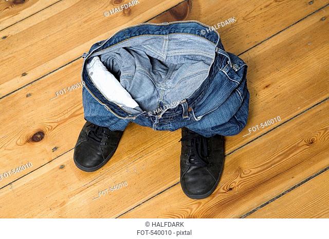 Crumpled jeans on a pair of shoes