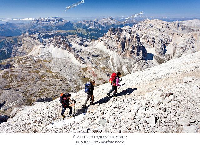 Mountain climbers during the ascent of Mt Tofana di Roze on the Via Ferrata Giovanni Lipella, Sella Massif at back, Dolomites