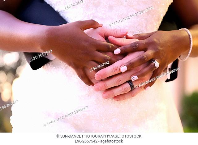 multi cultural couple embracing - close up on hands