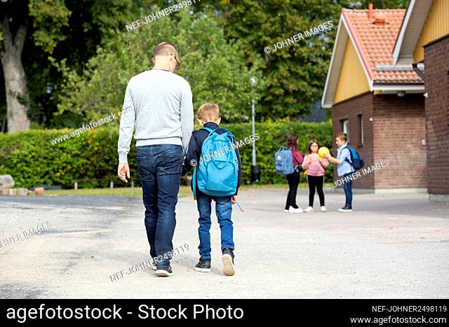 Father taking boy to school
