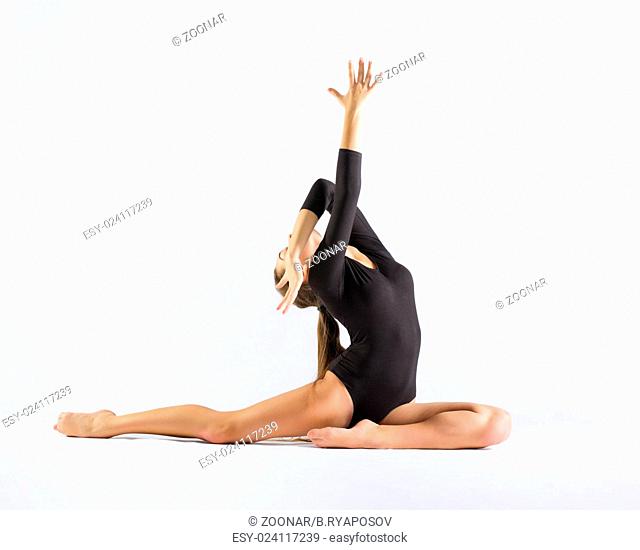 Young girl engaged art gymnastic on grey