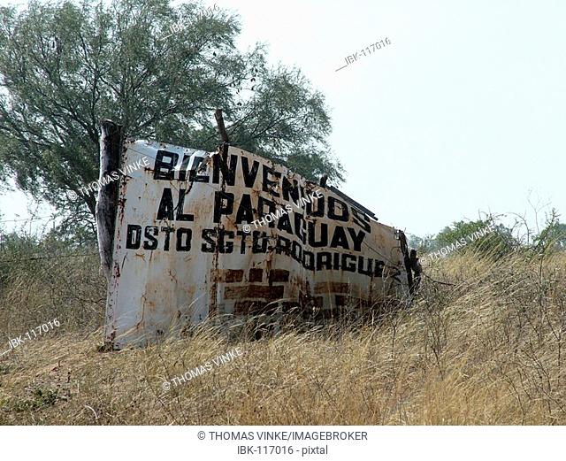 Paraguayan dented and rusted sign for welcoming people at the deserted border between Paraguay and Bolivia, Gran Chaco
