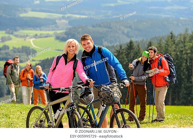 Sporty cyclist couple hikers springtime weekend