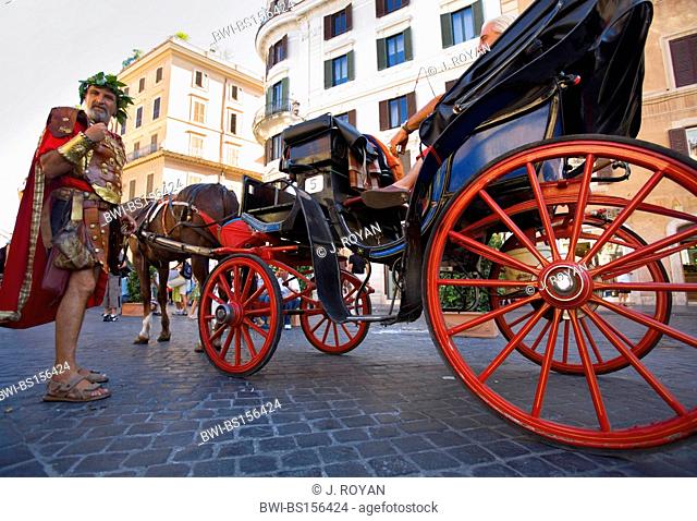 a man dressed as a roman soldier standing near horse drawn carriages on the Piazza Spagna, Italy, Rome