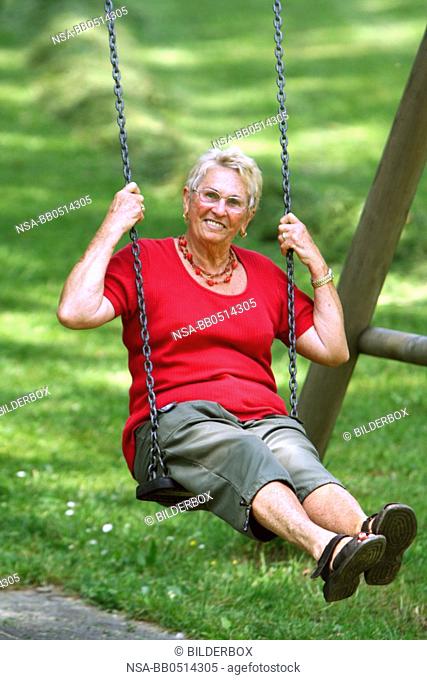 Laughing Senior on swing