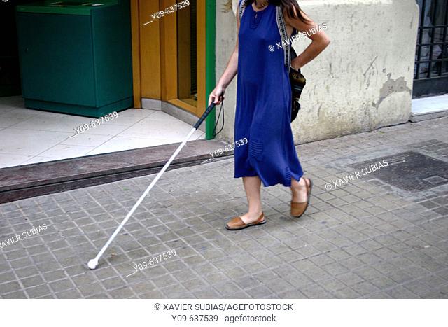 Blind woman using walking stick