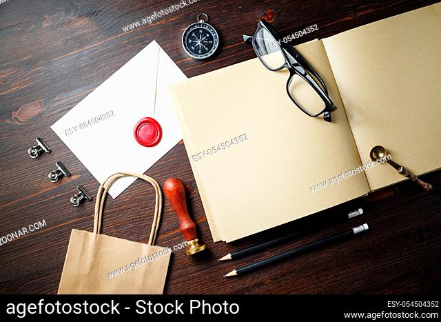 Photo of blank retro stationery set on wood table background. Flat lay
