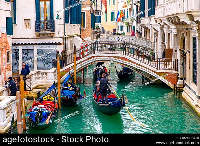 Gondola, the traditional Venetian boat, on canal with tourists, Venice, Italy