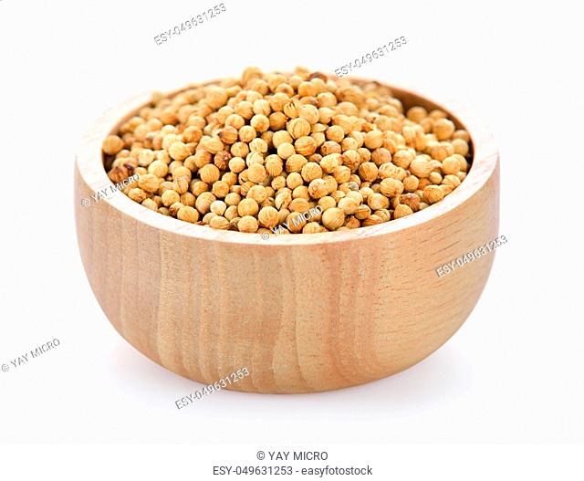 Coriander seeds in wood bowl