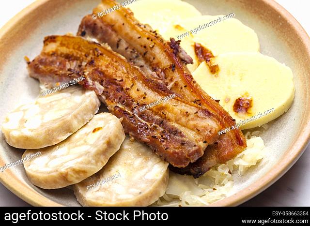 pork meat with two types of dumplings and cabbage