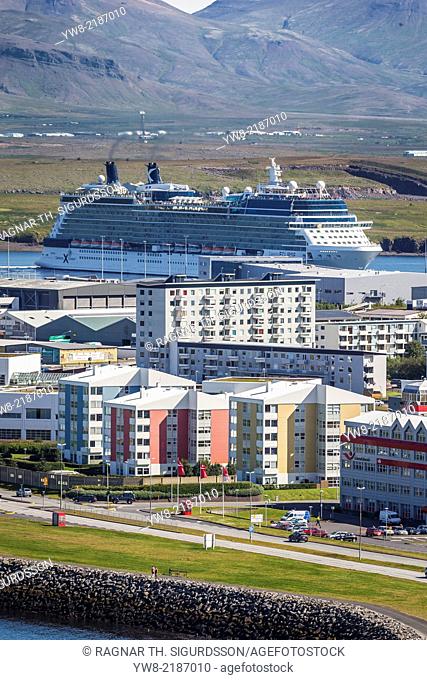 Apartment buildings with a large Cruise ship in Reykjavik Harbor, Iceland
