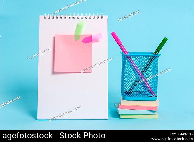 Spiral notebook sticky note banners stacked pads pens holder pastel back