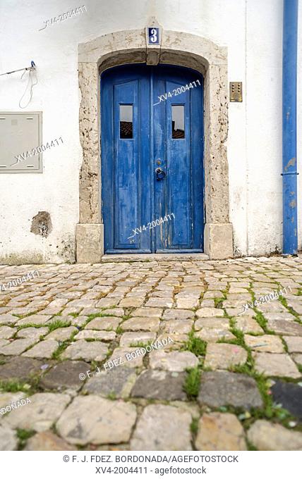 Facade with Blue door. Narrow streets around Castelo Sao Jorge. Alfama. Lisboa. Portugal. Europe