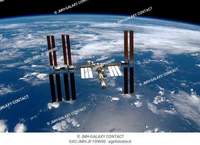 Backdropped by a blue and white Earth and the blackness of space, the International Space Station is seen from Space Shuttle Endeavour as the two spacecraft...