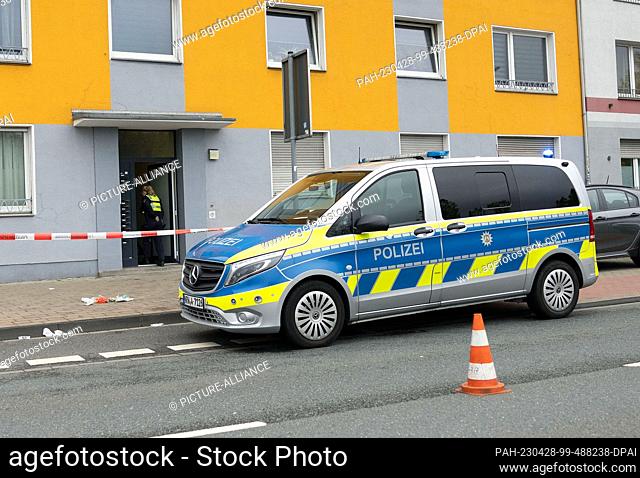 28 April 2023, North Rhine-Westphalia, Duisburg: A policewoman walks into a house in Duisburg. A 53-year-old woman suffered life-threatening injuries in a...