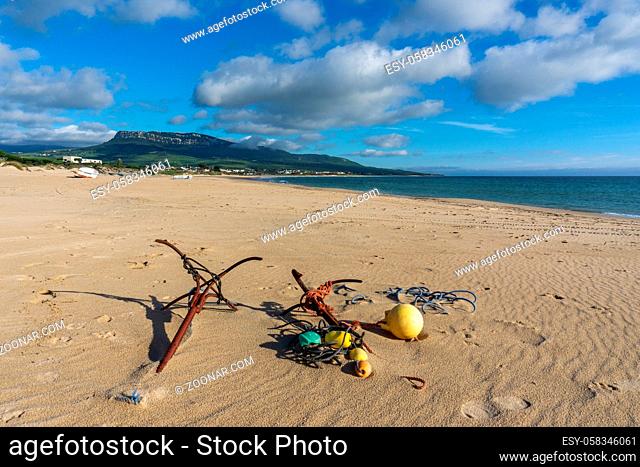 Two old metal anchors on a sandy beach on the Costa de la Luz in Andalusia