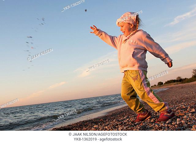 Young Girl Throwing Stone into Water