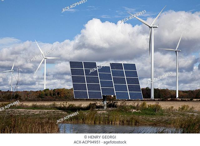 Solar panels on tracking system and windmills in farmland of southwestern Ontario (near Lake Erie), Ontario, Canada