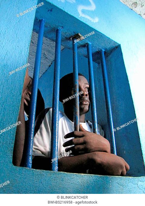 detainees behind bars of a window in run-down predetention cell (garde Ó vue) at police station, commissariat of JÚrÚmie, Haiti, Grande Anse, Jeremie