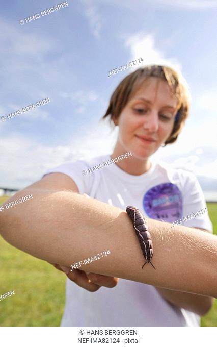 Larva crawling on girls arm