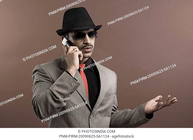 Actor portraying a businessman talking on a mobile phone