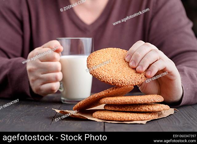 Breakfast with Round cookie with sesame seeds and cup of milk