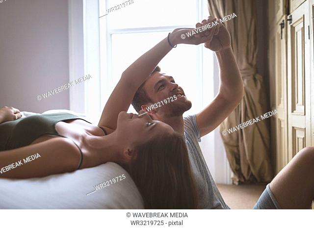 Couple having fun in bedroom