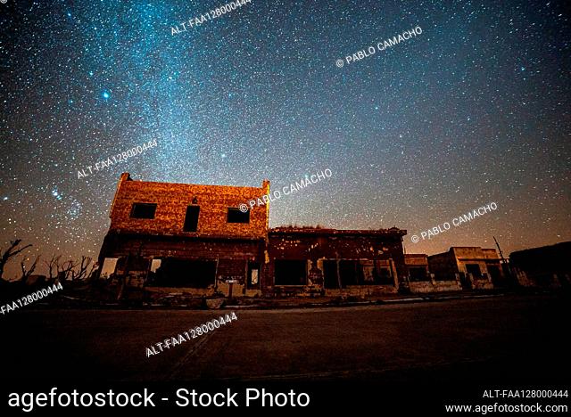 View of abandoned shops and houses against milky way in sky, Villa Epecuen