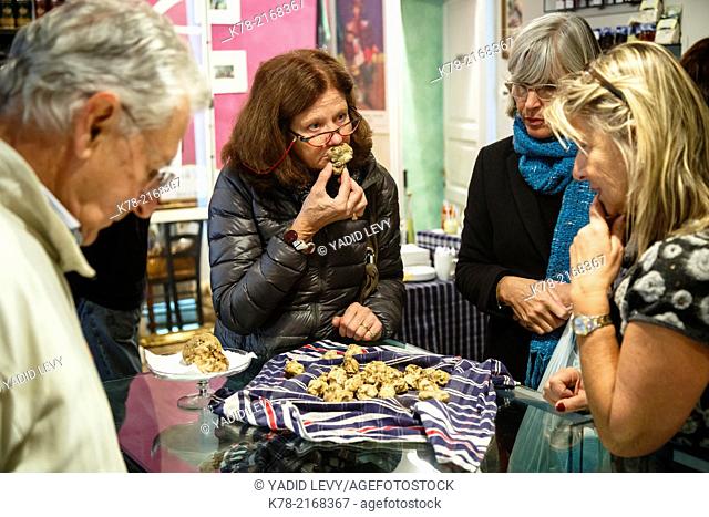 People looking at white truffles in Tartufo & Co. shop in Alba, Langhe, Cueno, Piedmont, Italy