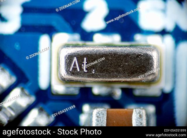 macro photo of a quartz resonator on the board pcb