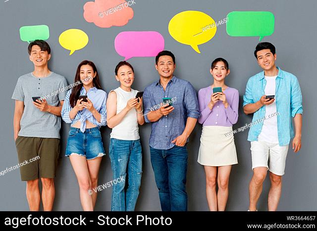 In the happy young people use mobile phone chat software to communicate