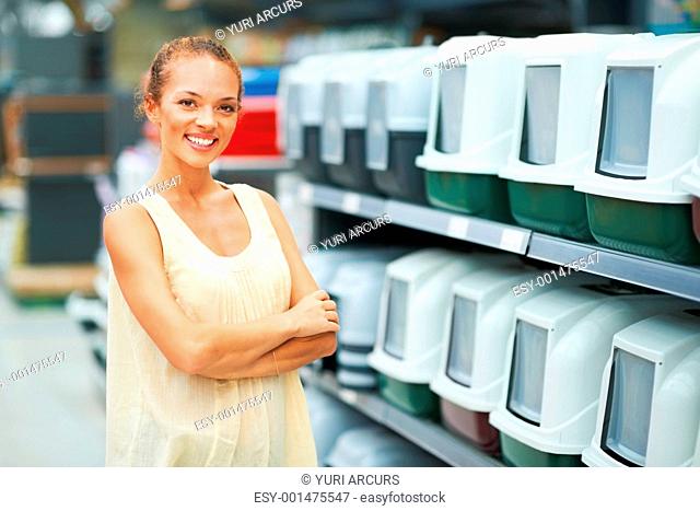 Portrait of woman smiling with hands folded at petshop