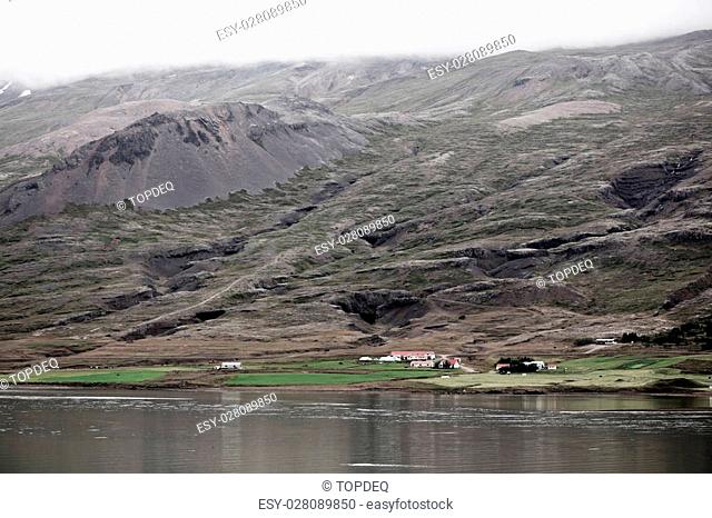 Icelandic Landscape: Farm in Foggy Mountains. Horizontal shot