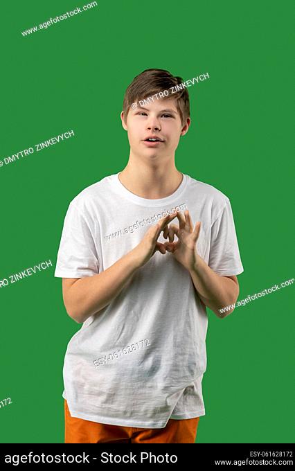 Front view of a calm teenager forming the heart shape with both hands in front of the camera