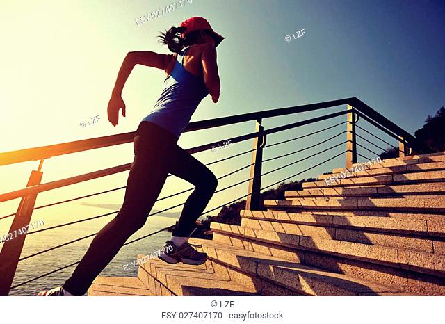 healthy lifestyle sports woman running on stone stairs sunrise seaside