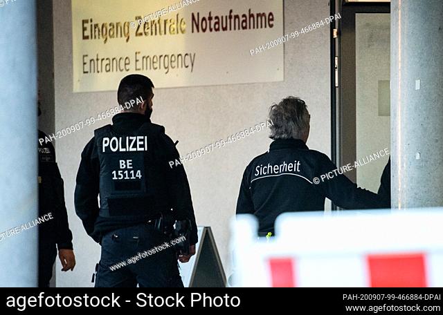 07 September 2020, Berlin: Policemen and security staff are standing in front of the entrance to the central emergency room of the Berlin Charité