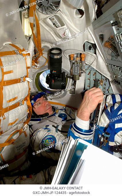 NASA astronaut Michael Barratt, Expedition 20 flight engineer, attired in a Russian Sokol launch and entry suit, occupies his seat in the Soyuz TMA-14 during...