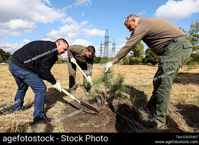 RUSSIA, DONETSK - OCTOBER 5, 2023: Donetsk Mayor Alexei Kulemzin (R) and Donetsk People's Republic Head Denis Pushilin (C) plant cedars in Alexander...