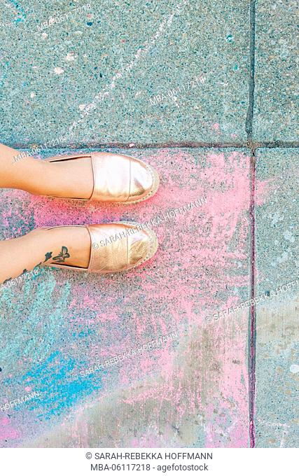 coloured sidewalk chalk, feet with summery sandals