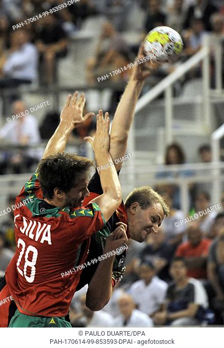 GermanyÂ·s Julius Kuhn challenges for the ball with PortugalÂ·s Jorge Silva during the Euro 2018 Qualification Group 5 handball match between Portugal and...