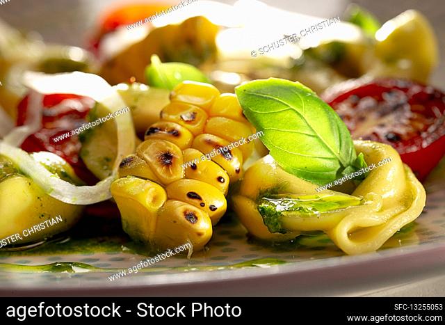 Tortellini with cocktail tomatoes, grilled corn and basil pesto
