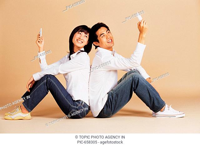 Young Korean Couple Using Mobile